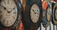 a group of clocks on a wall